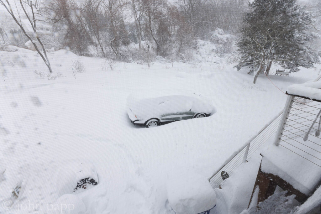 Volvo covered with snow in driveway