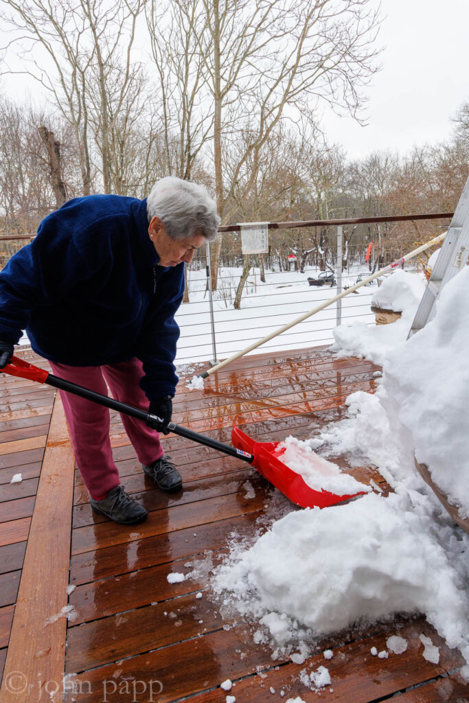 Great grandmother, Henrietta 95 pitches in to dig out the deck.